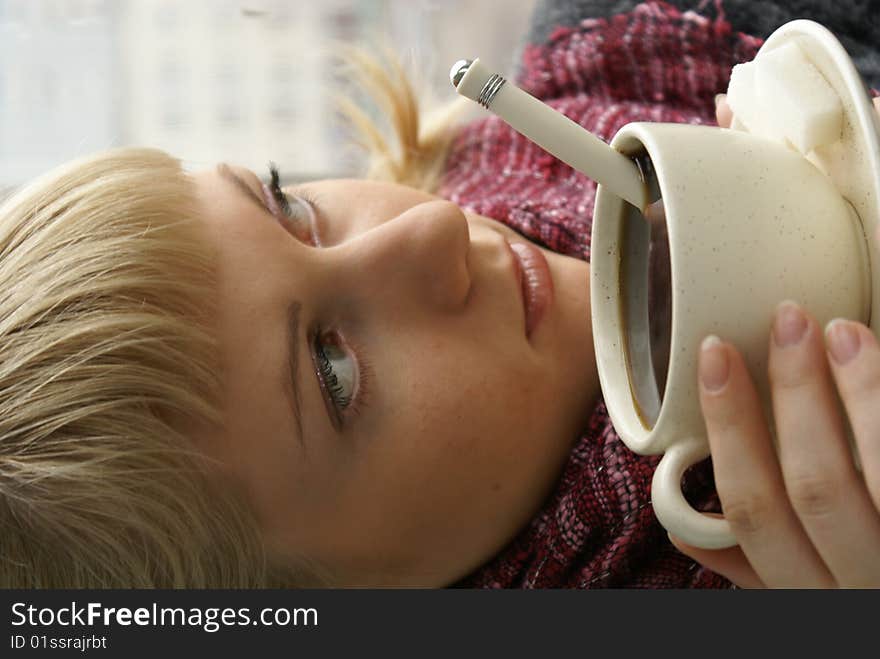 Beautiful young girl with a cup of hot coffee drink. Beautiful young girl with a cup of hot coffee drink