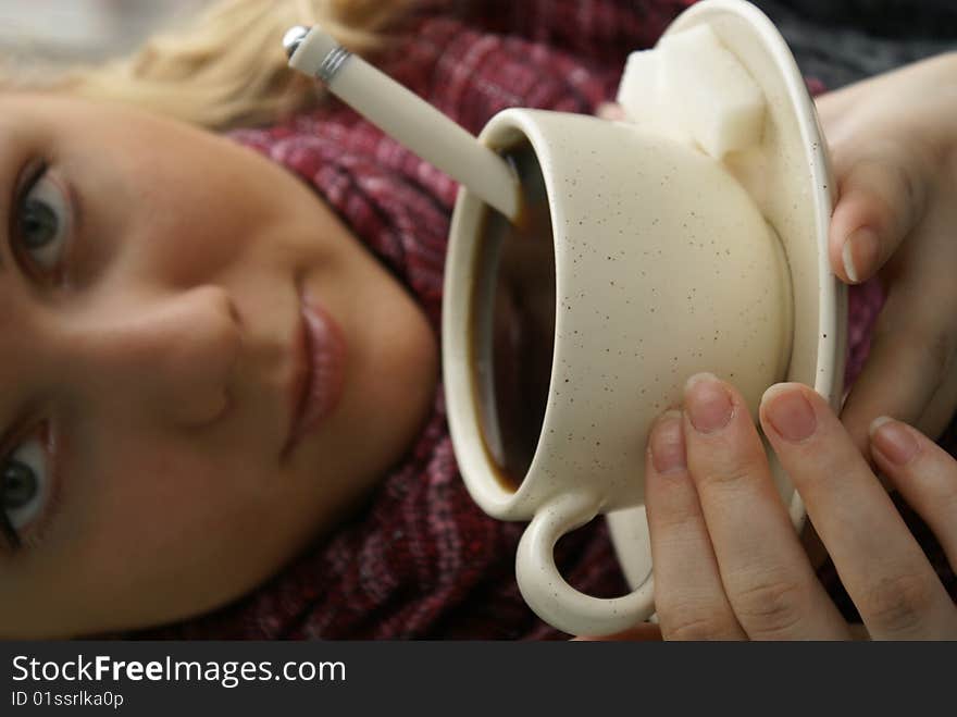 Beautiful young girl with a cup of hot coffee drink. Beautiful young girl with a cup of hot coffee drink