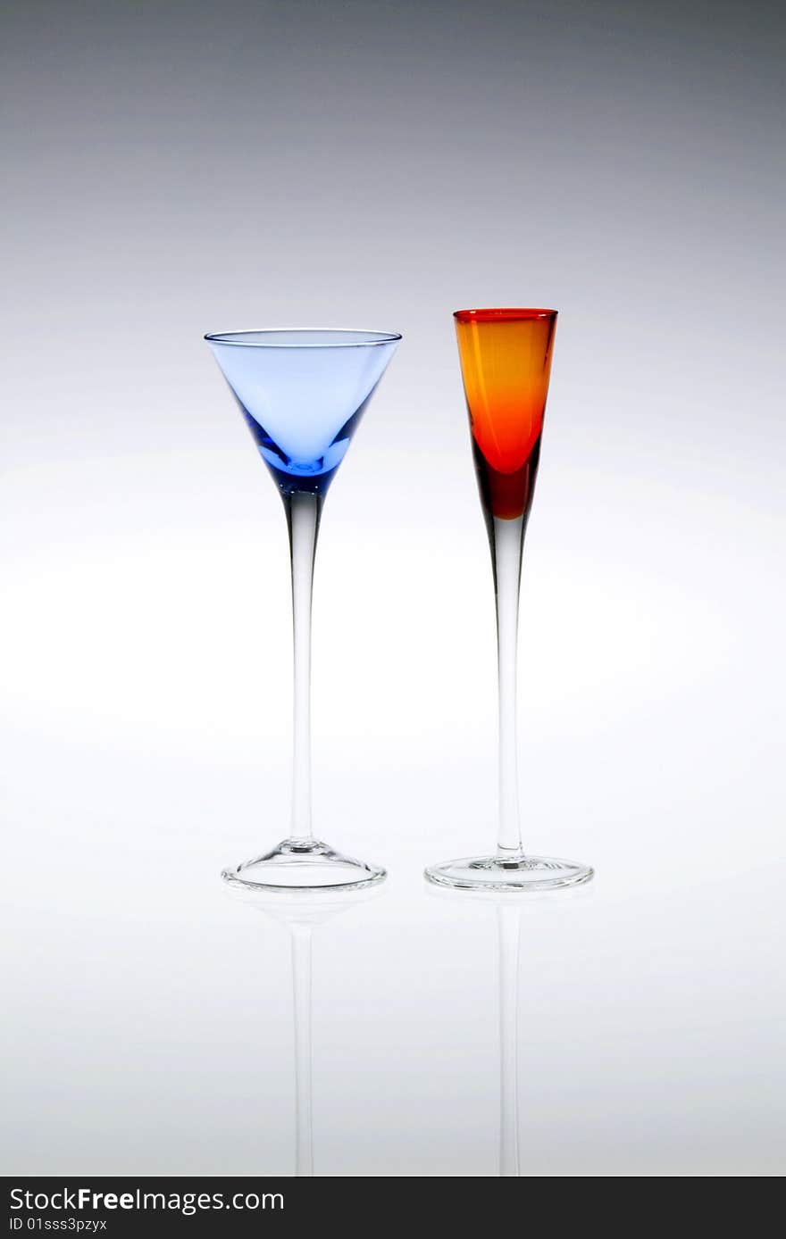 Blue and orange cordial, aperitif or liqueur glasses, empty. Blue and orange cordial, aperitif or liqueur glasses, empty.