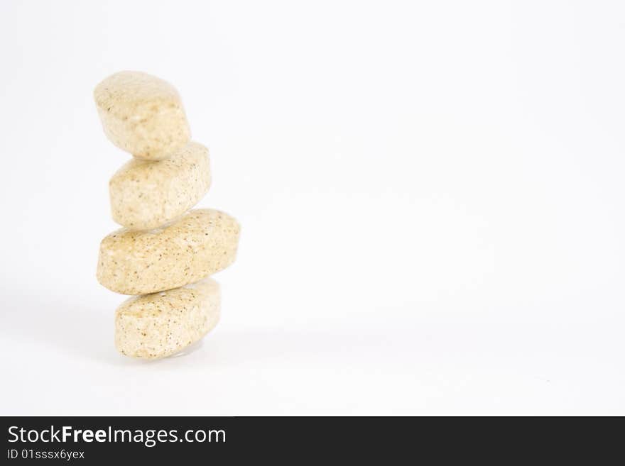 Stack of four speckled vitamin supplements. Stack of four speckled vitamin supplements