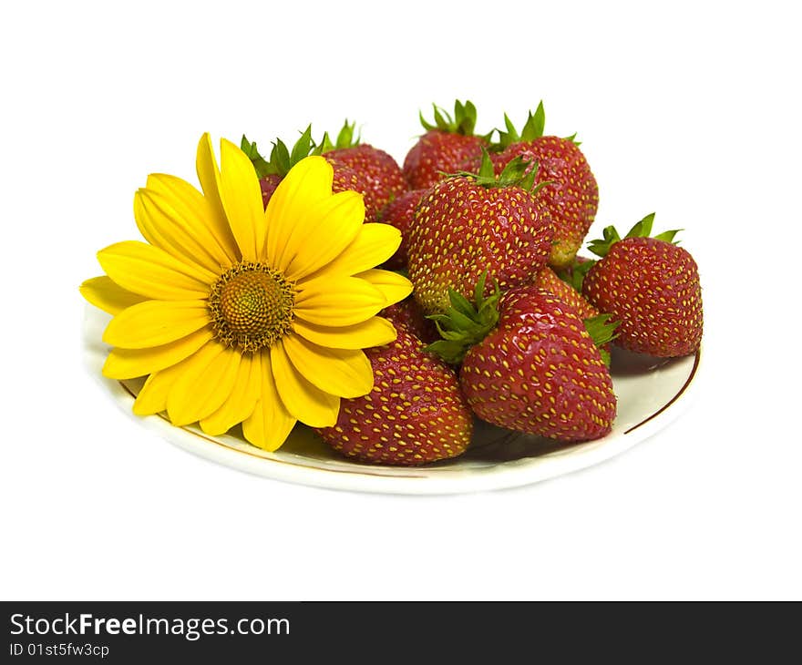 Strawberries and yellow flower isolated on white