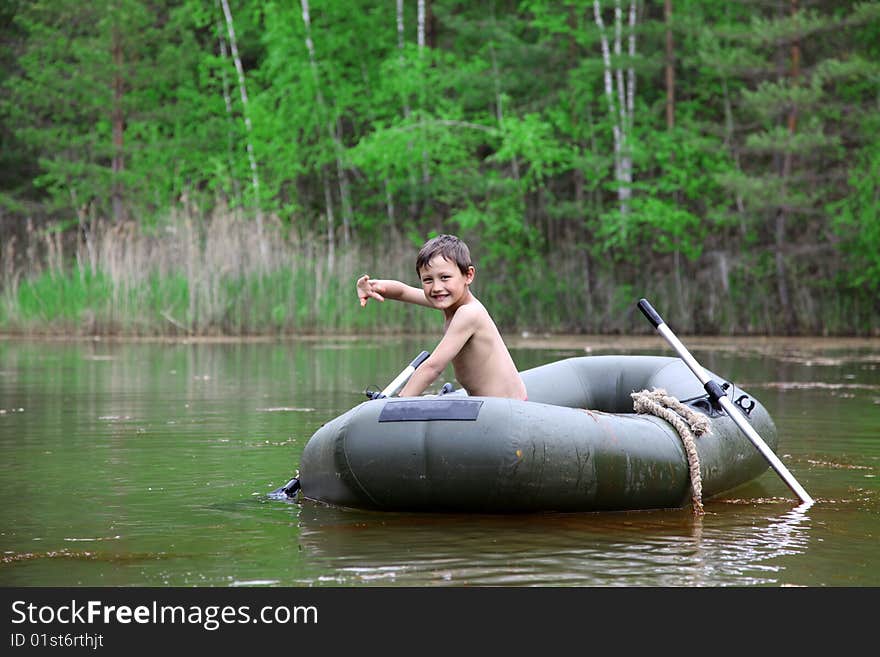 Boy in boat  at forest like