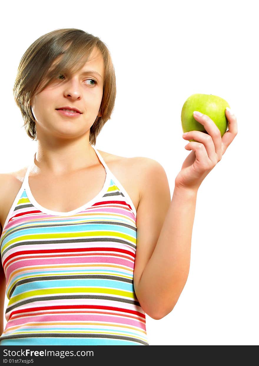 Portrait of a beautiful Caucasian blond girl with a nice colorful striped dress who is smiling and she is holding a green apple in her hand. Isolated on white. Portrait of a beautiful Caucasian blond girl with a nice colorful striped dress who is smiling and she is holding a green apple in her hand. Isolated on white.