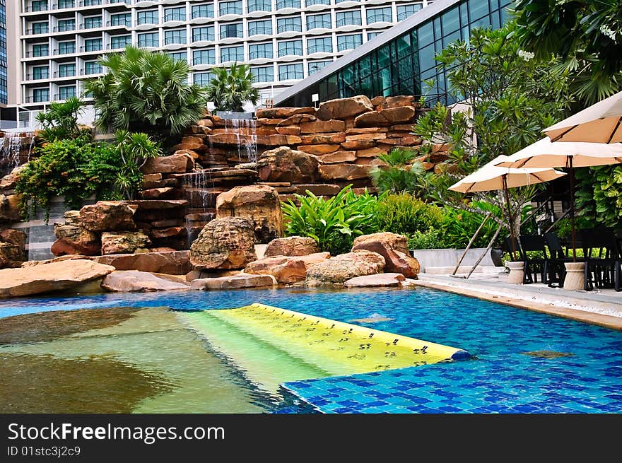 Sunbeds and umbrellas near resort's pool. Sunbeds and umbrellas near resort's pool