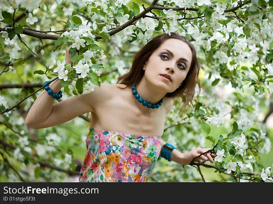 Tender girl in the garden with flowerings trees