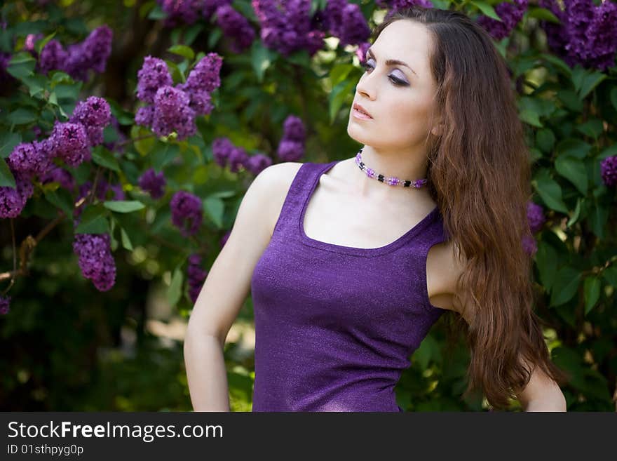 Tender girl in the garden with lilac