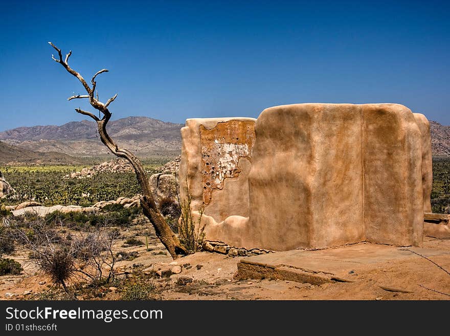 Old adobe building with the mountains in the background at Joshua Tree National State Park. Old adobe building with the mountains in the background at Joshua Tree National State Park