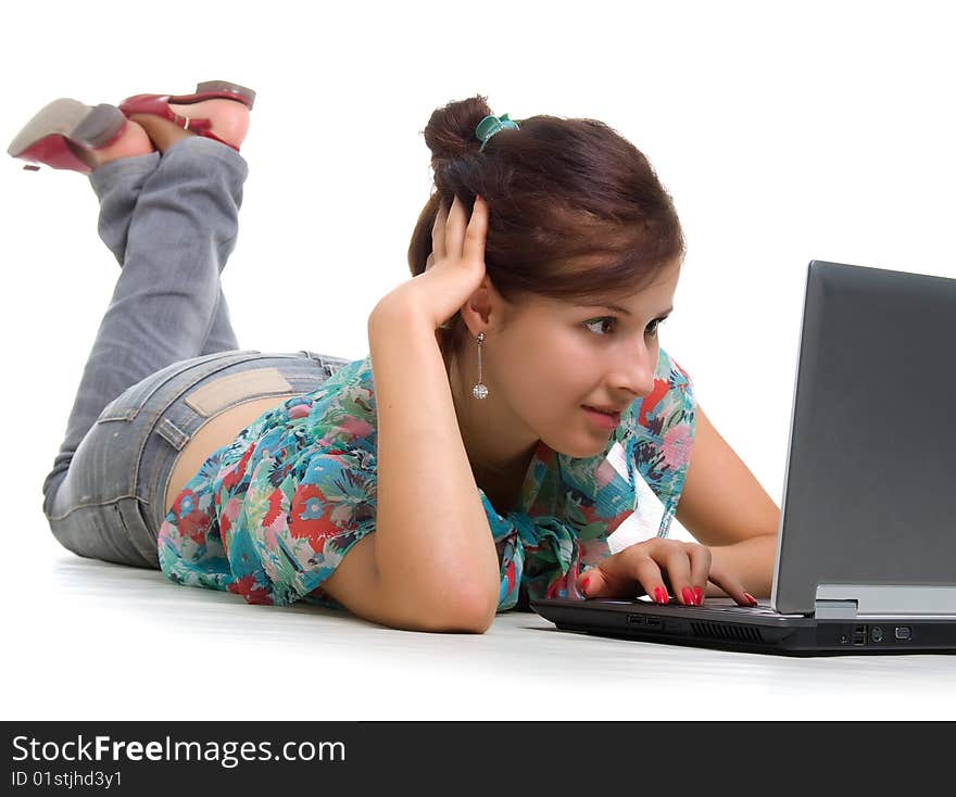 Cute young woman with laptop. Studio shot