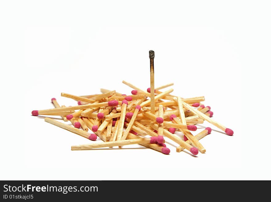 A Pile of red head matches with one single burnt out match in focus. A Pile of red head matches with one single burnt out match in focus