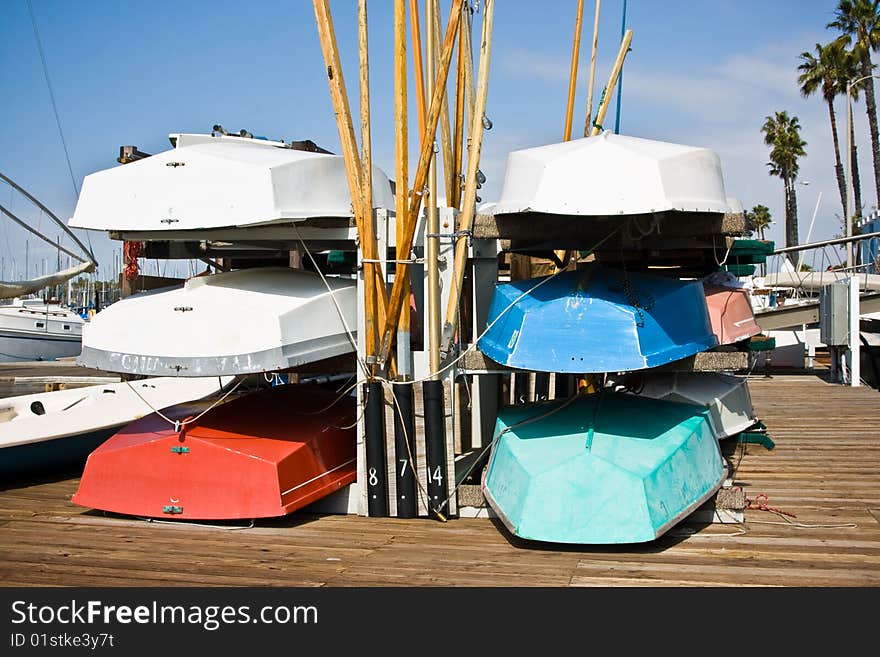 Six row boats on a dock in the Long Beach Harbor, California.