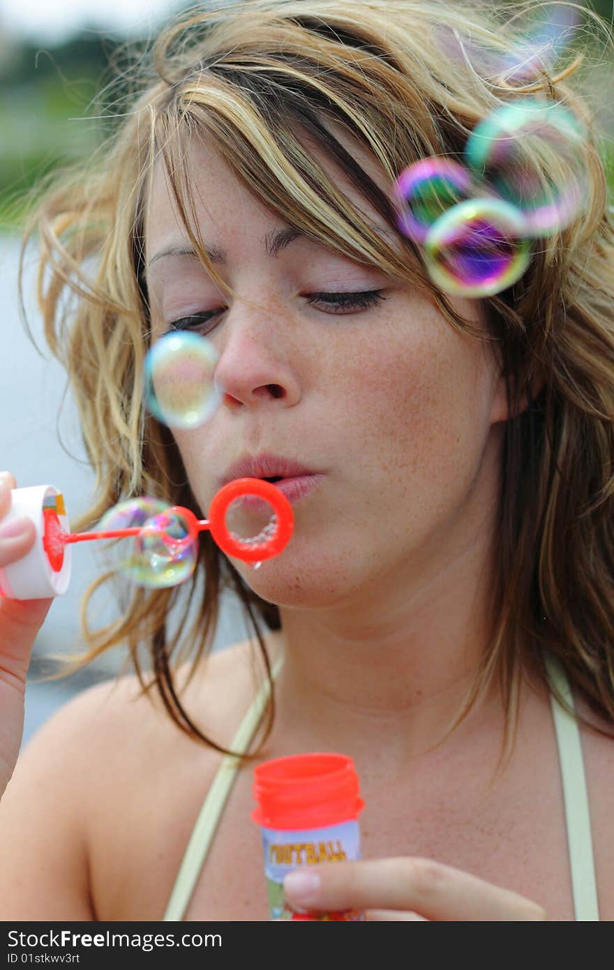 Beautiful woman is blowing bubbles. Beautiful woman is blowing bubbles