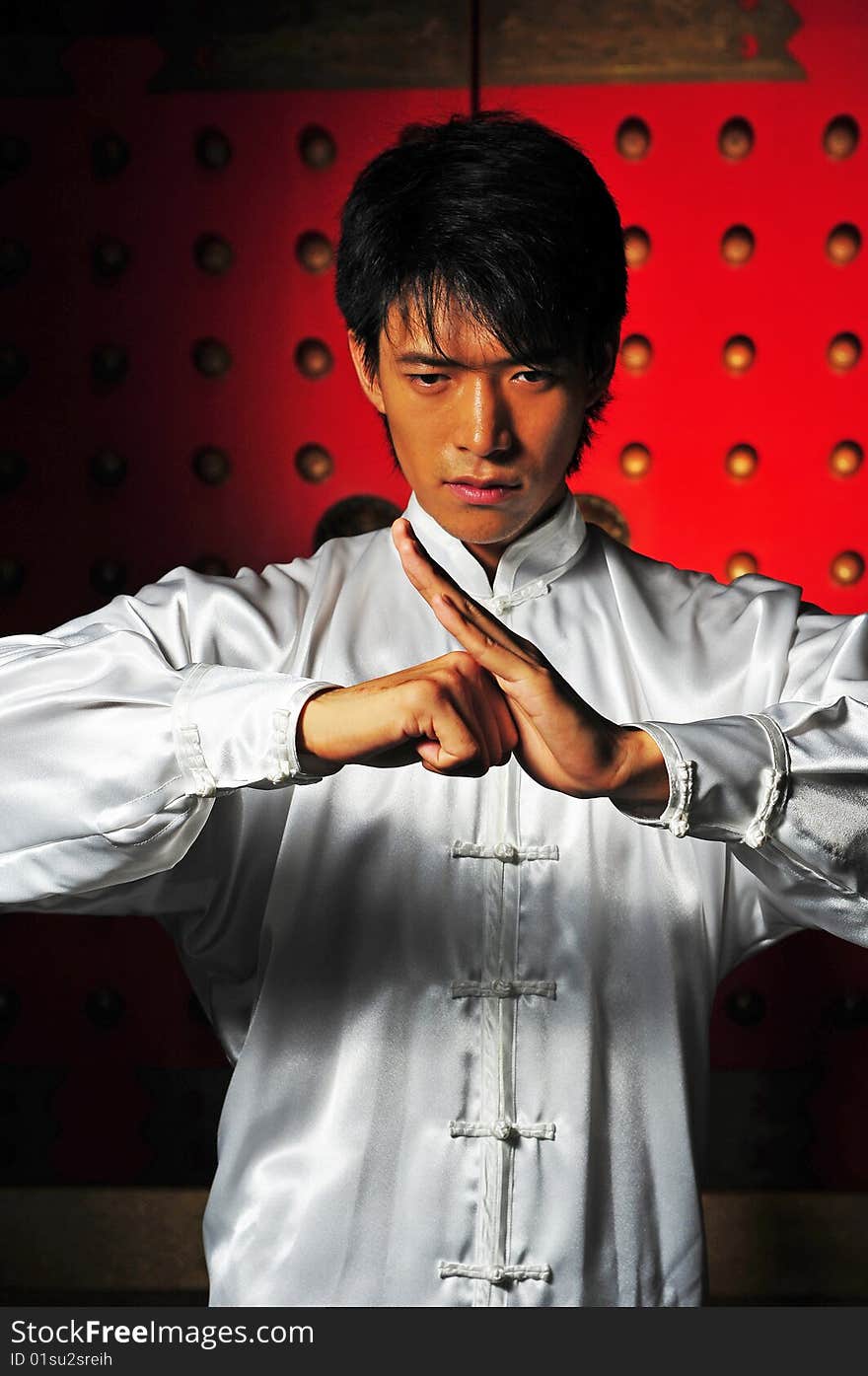 Young Asian Man In White Traditional Clothing In Oriental Theme. Young Asian Man In White Traditional Clothing In Oriental Theme