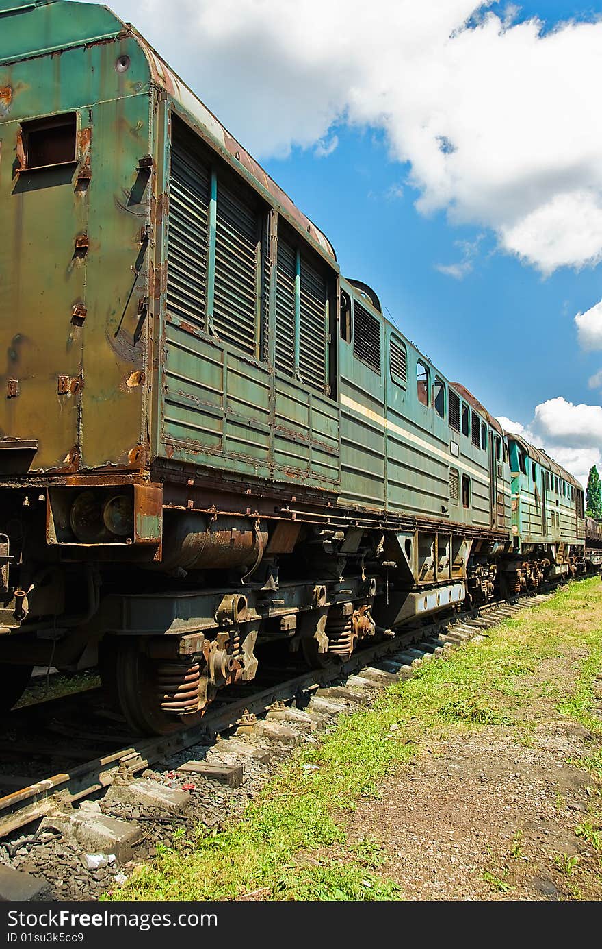 Unserviceable trains on rails under blue sky. Unserviceable trains on rails under blue sky