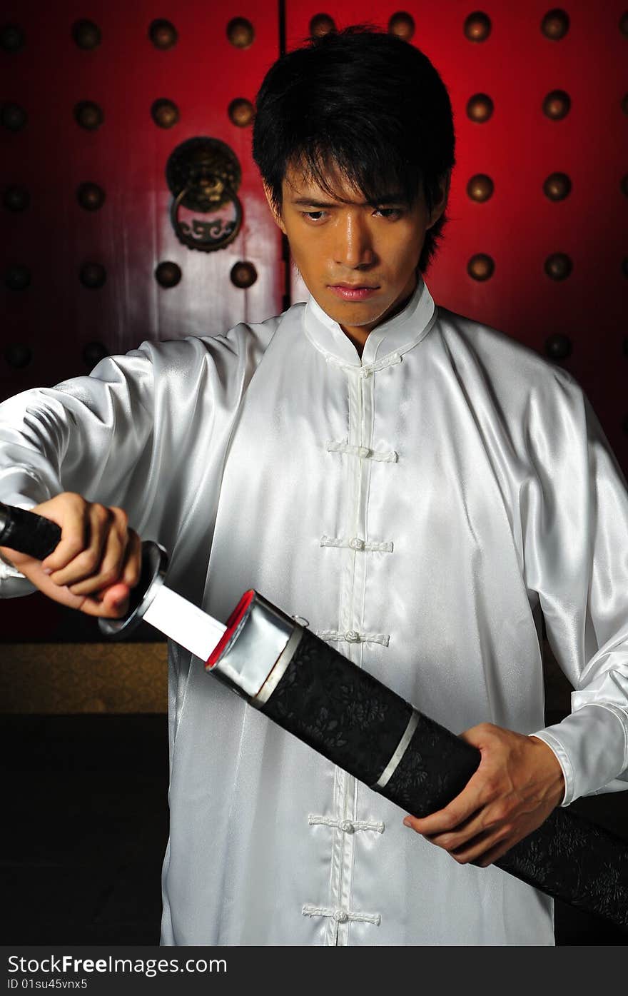 Young Asian Man In White Traditional Clothing In Oriental Theme. Young Asian Man In White Traditional Clothing In Oriental Theme