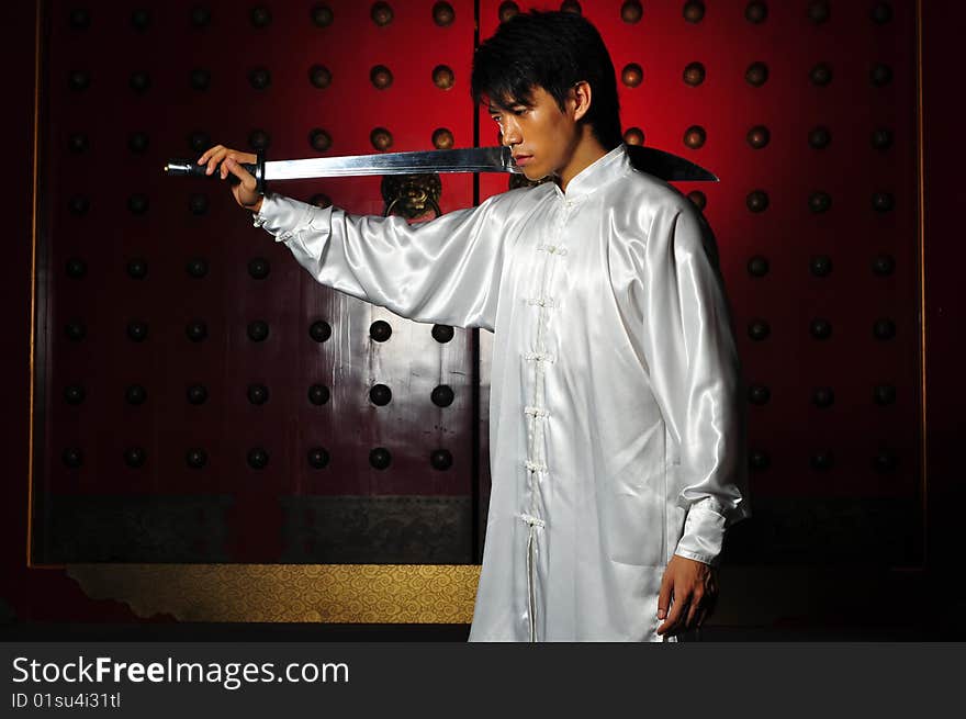 Young Asian Man In White Traditional Clothing In Oriental Theme. Young Asian Man In White Traditional Clothing In Oriental Theme