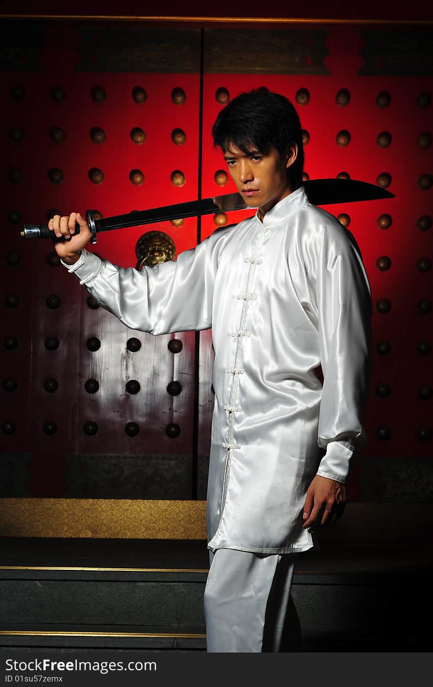 Young Asian Man In White Traditional Clothing In Oriental Theme. Young Asian Man In White Traditional Clothing In Oriental Theme