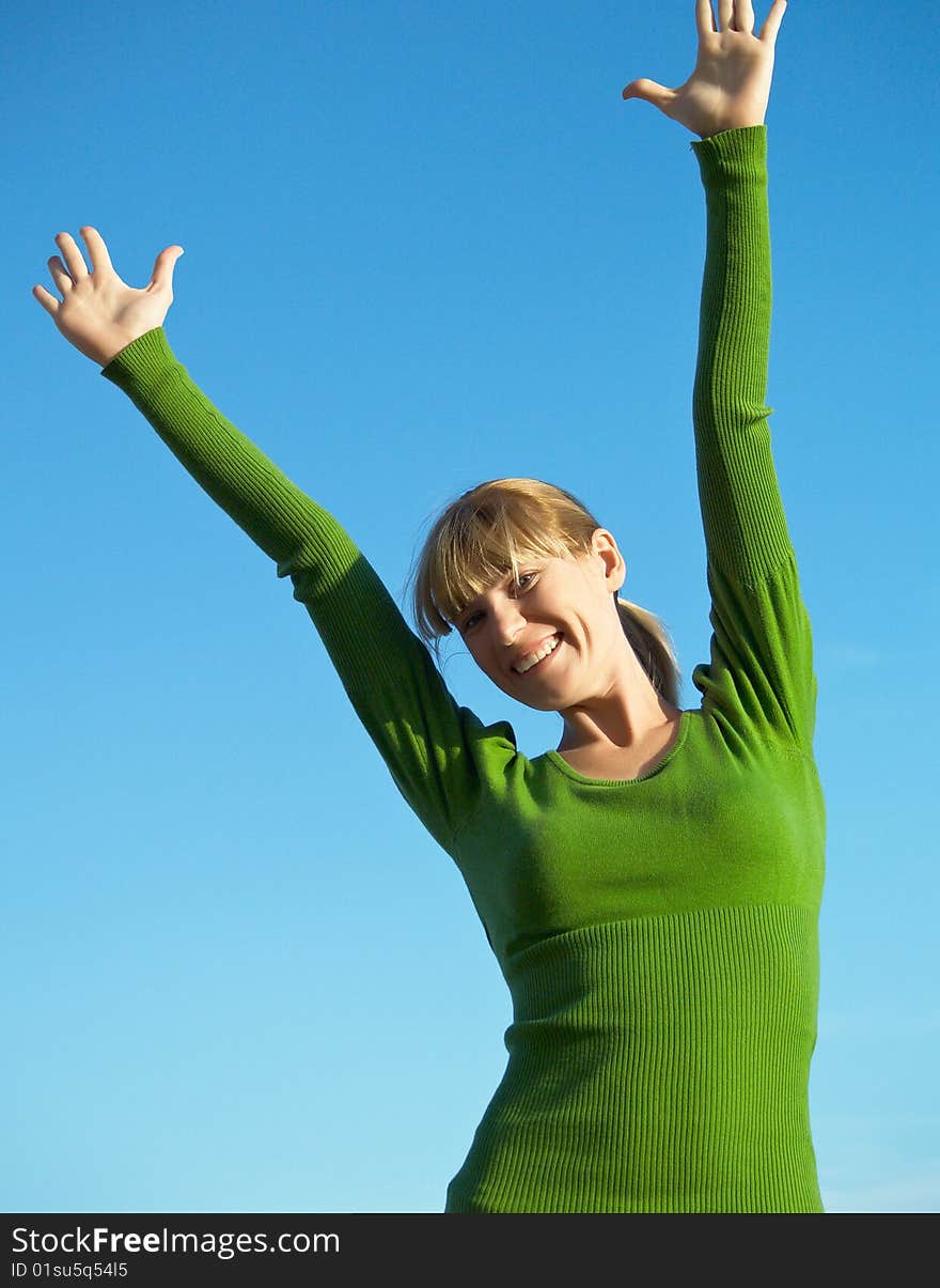 Portrait of the young woman posing on a background of the dark blue sky. Portrait of the young woman posing on a background of the dark blue sky