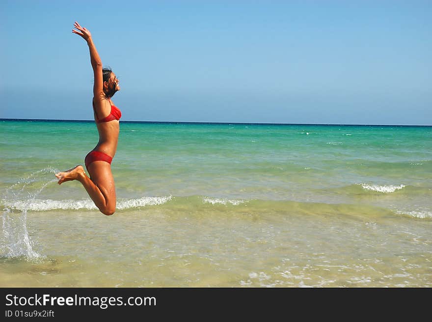 Slim women jumping under water