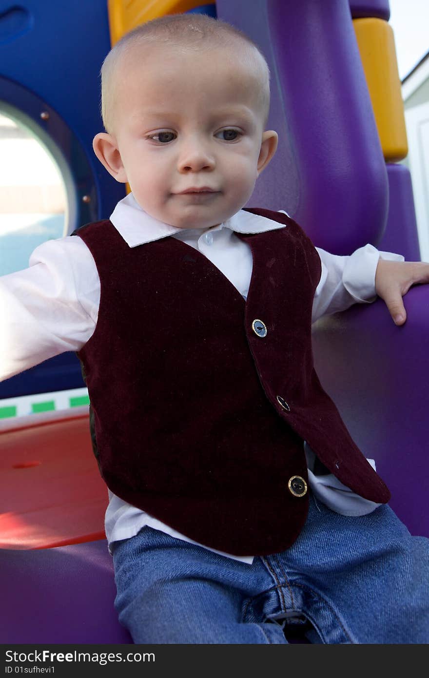 An interested little boy with big blue eyes and a bald head