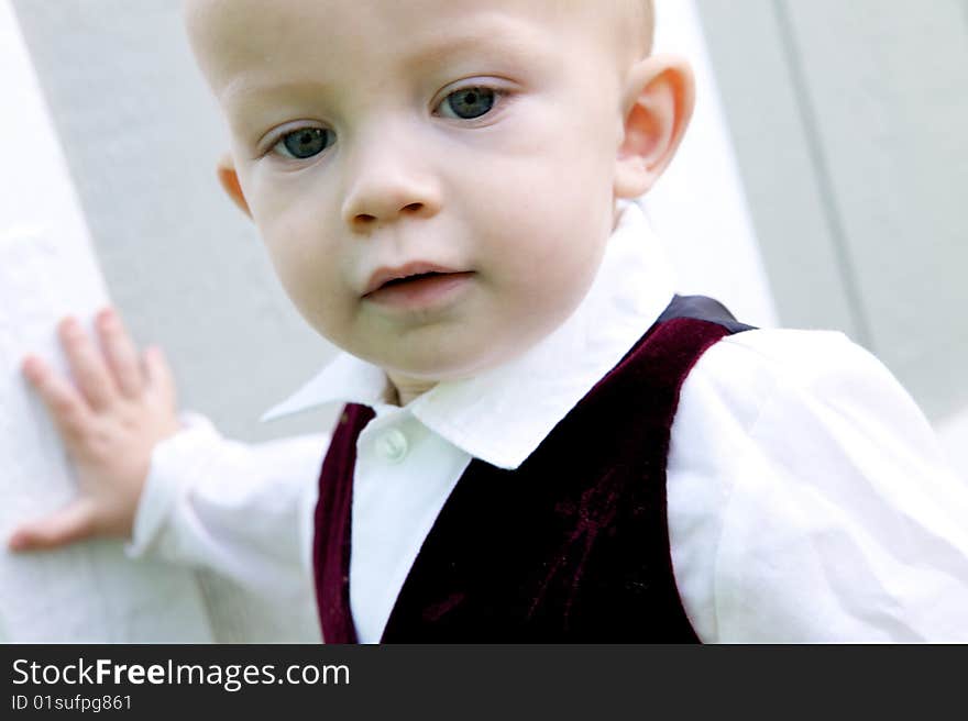 An interested little boy with big blue eyes and a bald head