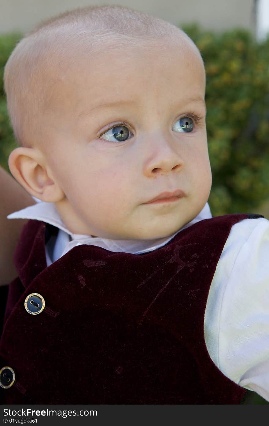 An interested little boy with big blue eyes and a bald head. An interested little boy with big blue eyes and a bald head