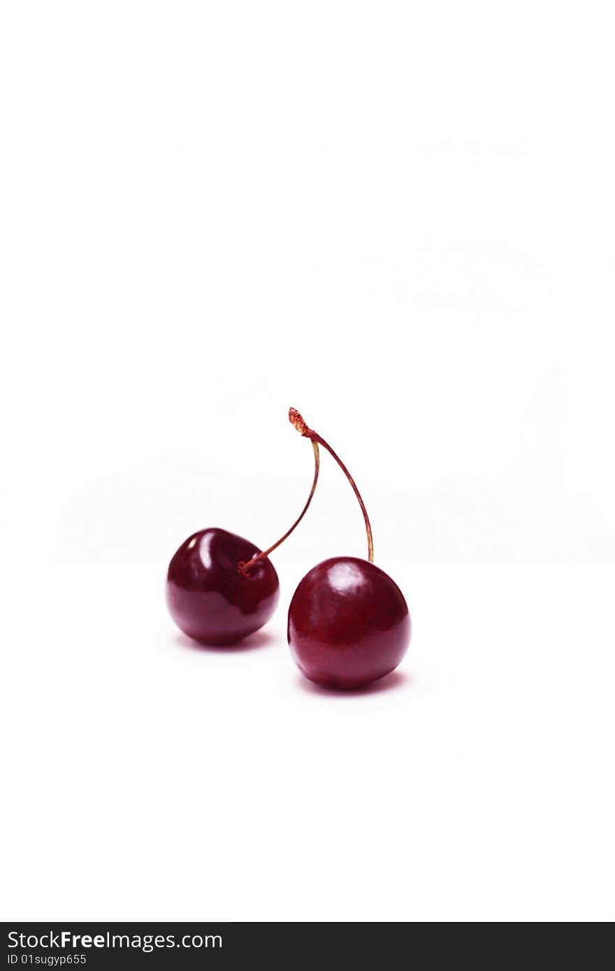 Two cherries close-up on a white background