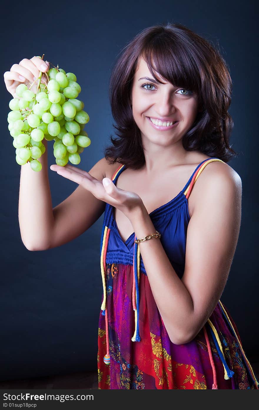 Beautiful girl with grapes cluster. Beautiful girl with grapes cluster