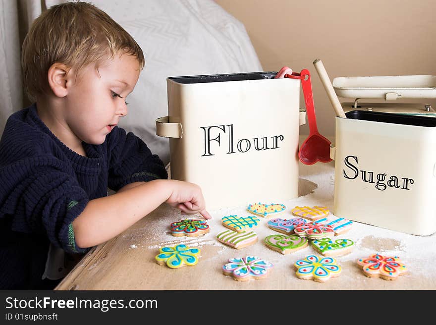 Blond toddler sitting at the kitchen table. Blond toddler sitting at the kitchen table