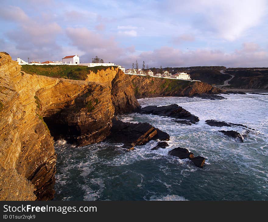 Small town of zambujeira in algarve, portugal. view of the rocks and the buildings on top