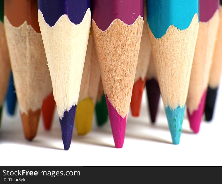 Macro of colored pencils over white