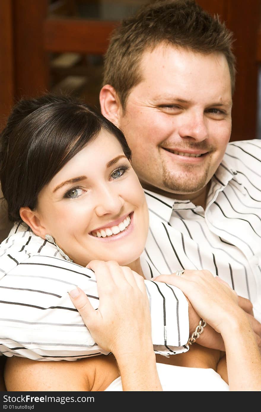 Beautiful brunette bride sitting by her groom. Beautiful brunette bride sitting by her groom