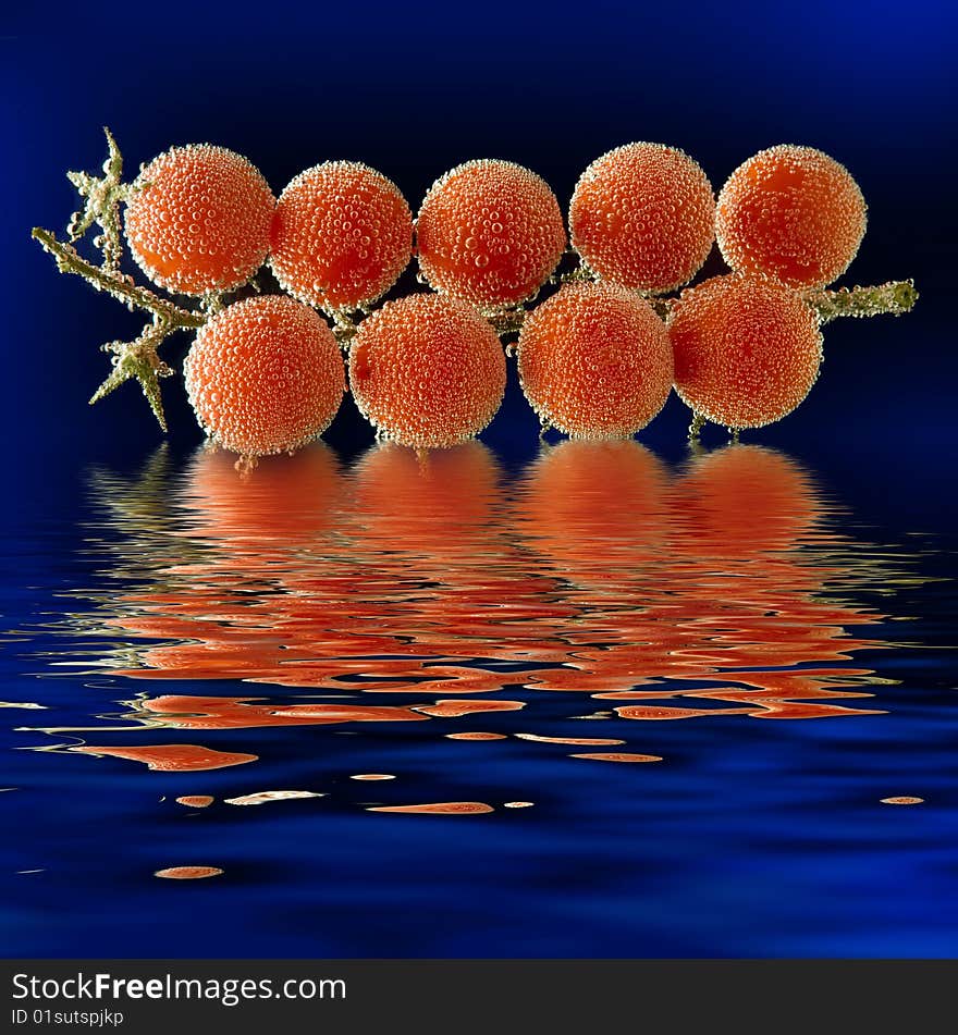 Tomato   with bubbles on black background