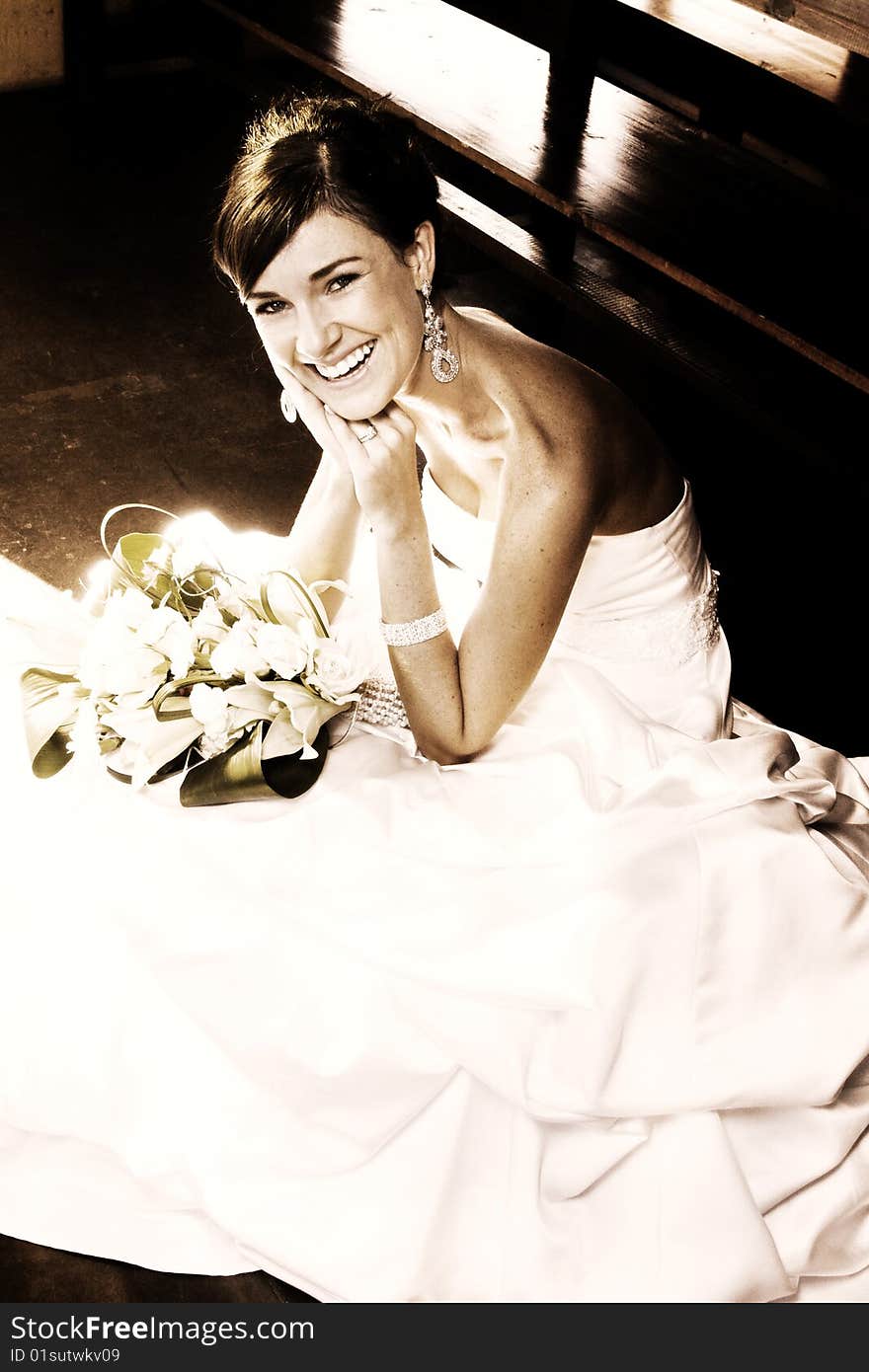 Beautiful brunette bride sitting on a step in the chapel. Beautiful brunette bride sitting on a step in the chapel