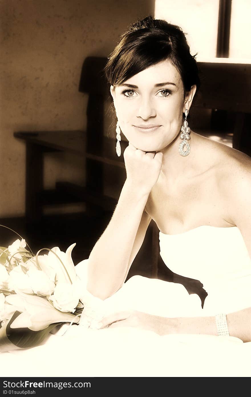 Beautiful brunette bride sitting on a step in the chapel. Beautiful brunette bride sitting on a step in the chapel