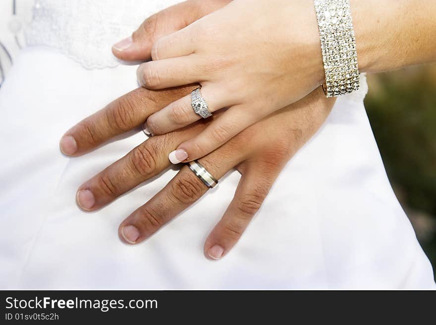 Bride gently holding her new groom's hand. Bride gently holding her new groom's hand