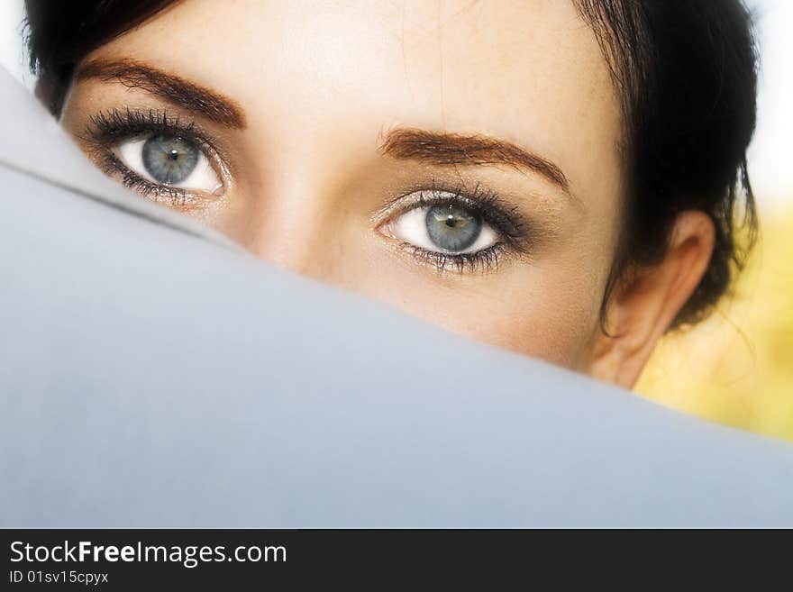 Beautiful brunette bride peeping over her groom's shoulder. Beautiful brunette bride peeping over her groom's shoulder