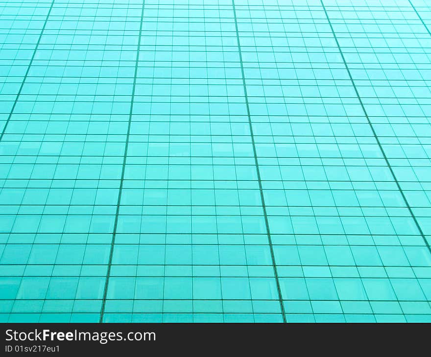 Metallic teal tinted grid from a building exterior. Metallic teal tinted grid from a building exterior