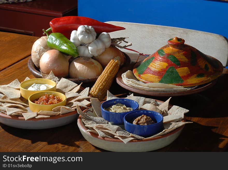 Nachos and pita bread with dips on the dinner table. Nachos and pita bread with dips on the dinner table