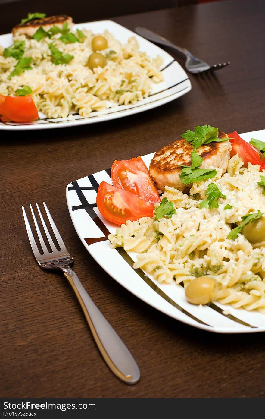 Plate of fusilli with fresh tomato and chop. Plate of fusilli with fresh tomato and chop