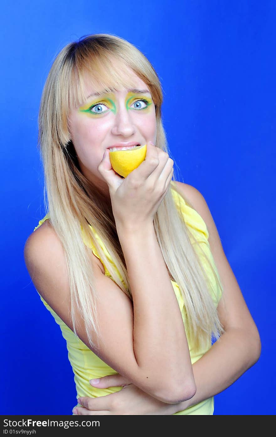 A blond girl with yellow lemon. A blond girl with yellow lemon