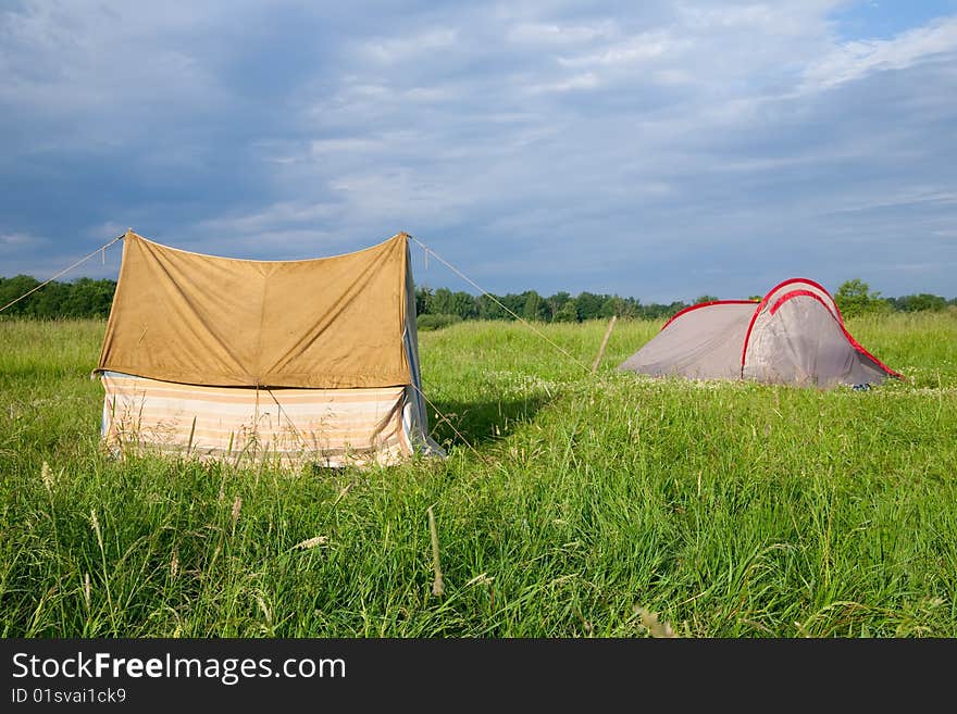 Two tourist tents on medow against nature