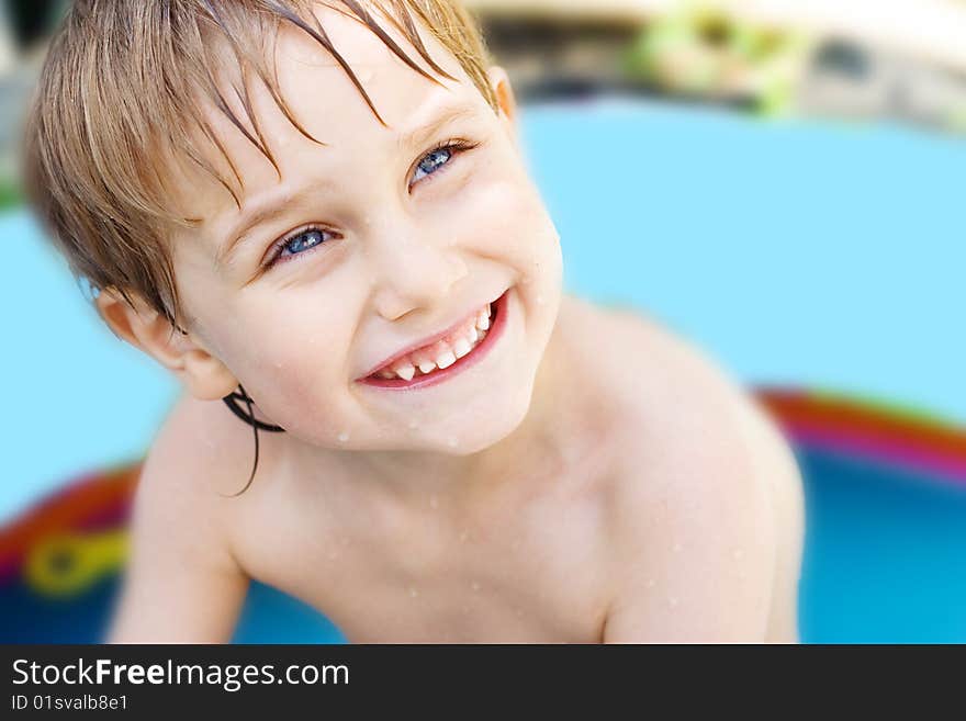 The boy bathes in inflatable pool