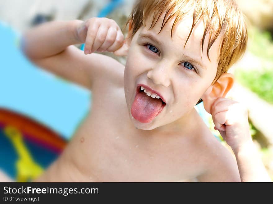 The boy bathes in inflatable pool