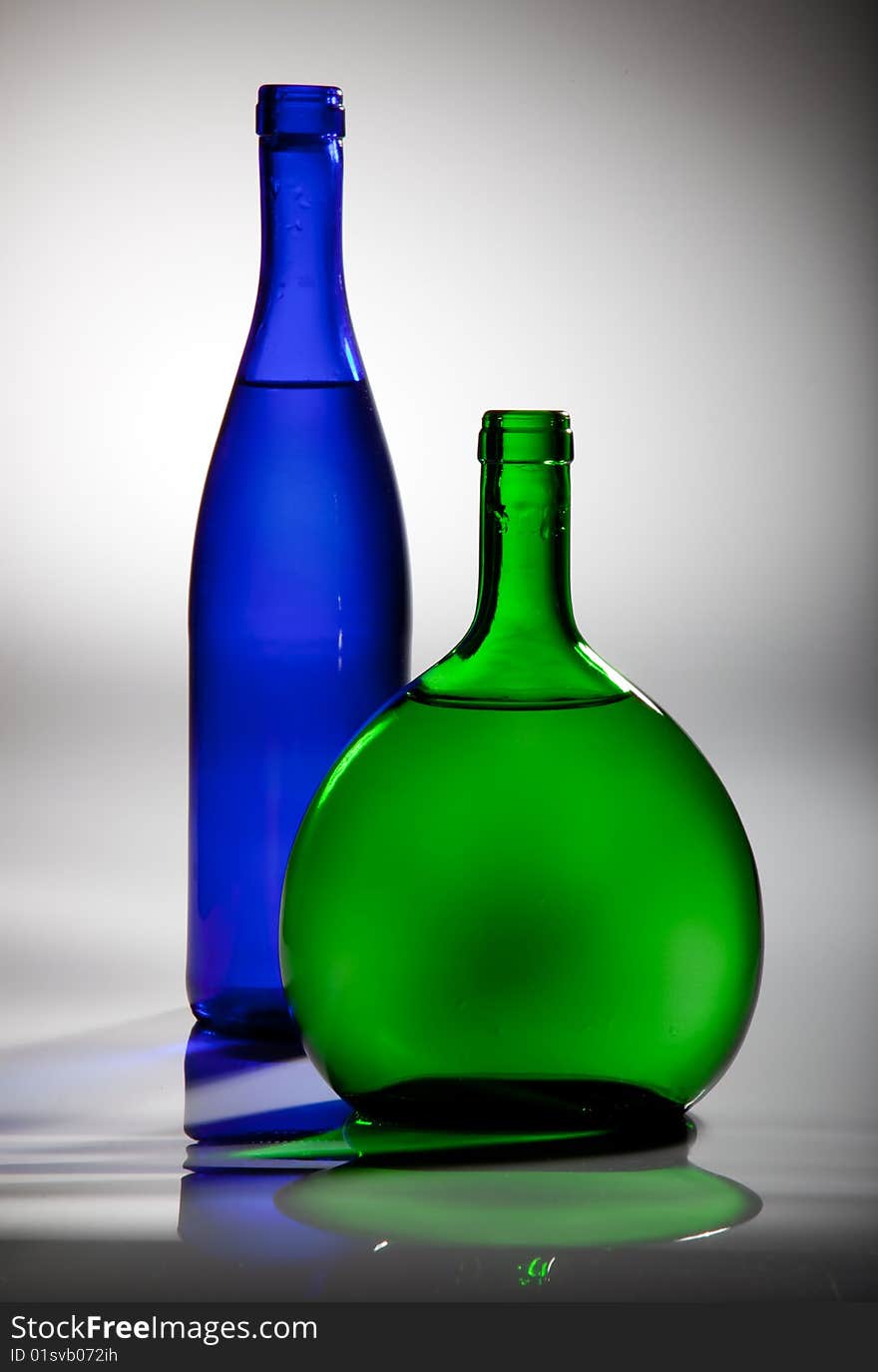 Two white wine bottles on a gray background