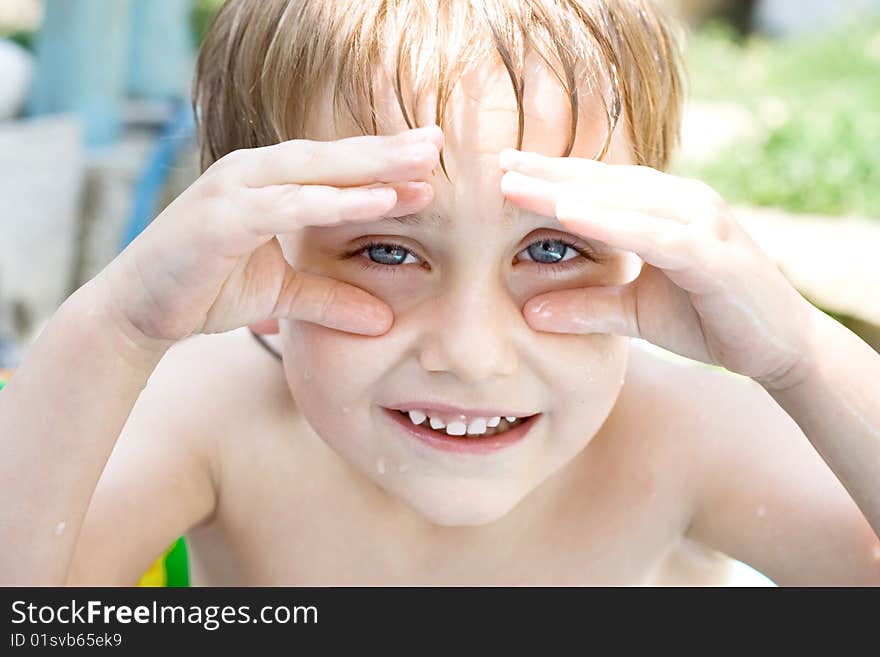 The boy bathes in inflatable pool