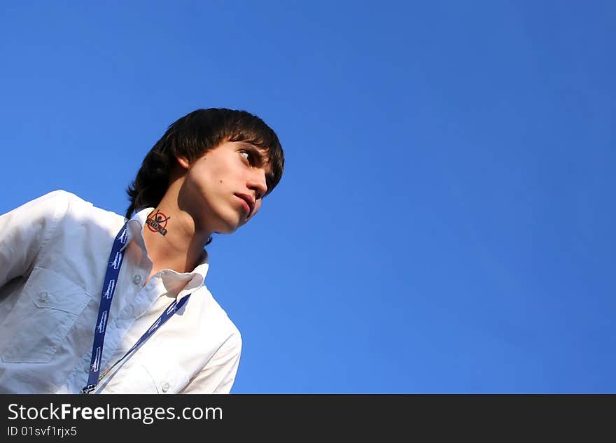 The young man against the blue sky