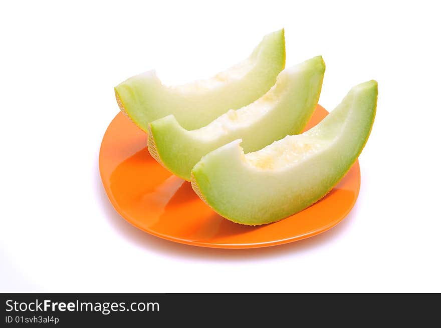 Juicy sliced melon on plate, isolated on white background.