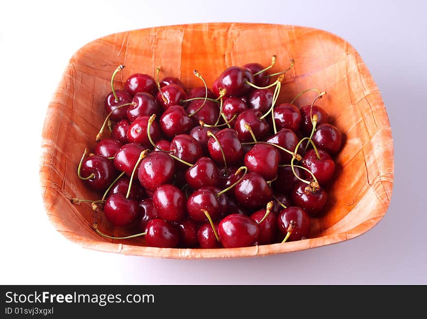 Fresh ripe cherries isolated in bamboo bowl. Fresh ripe cherries isolated in bamboo bowl