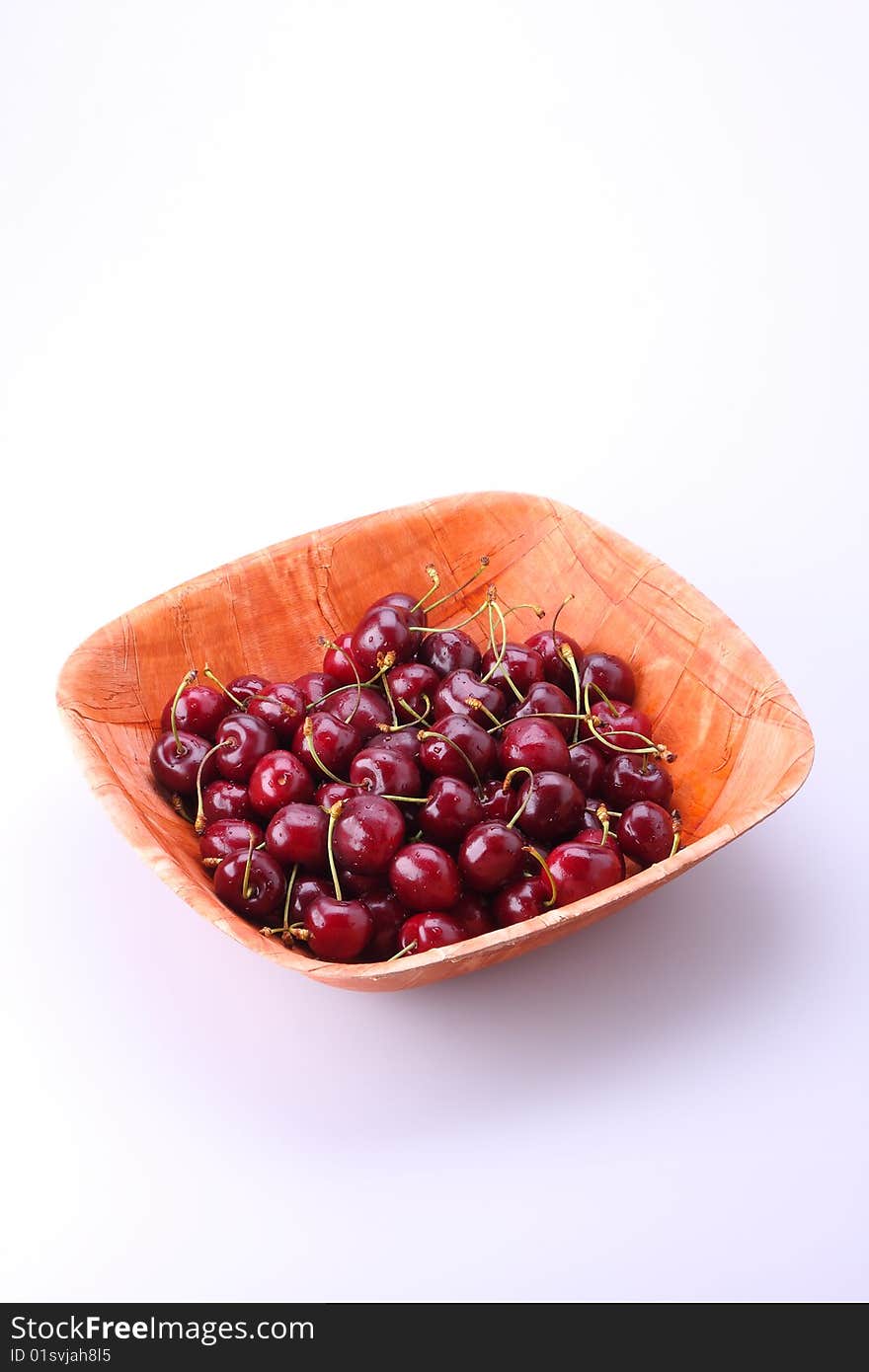 Fresh ripe cherries isolated in bamboo bowl. Fresh ripe cherries isolated in bamboo bowl