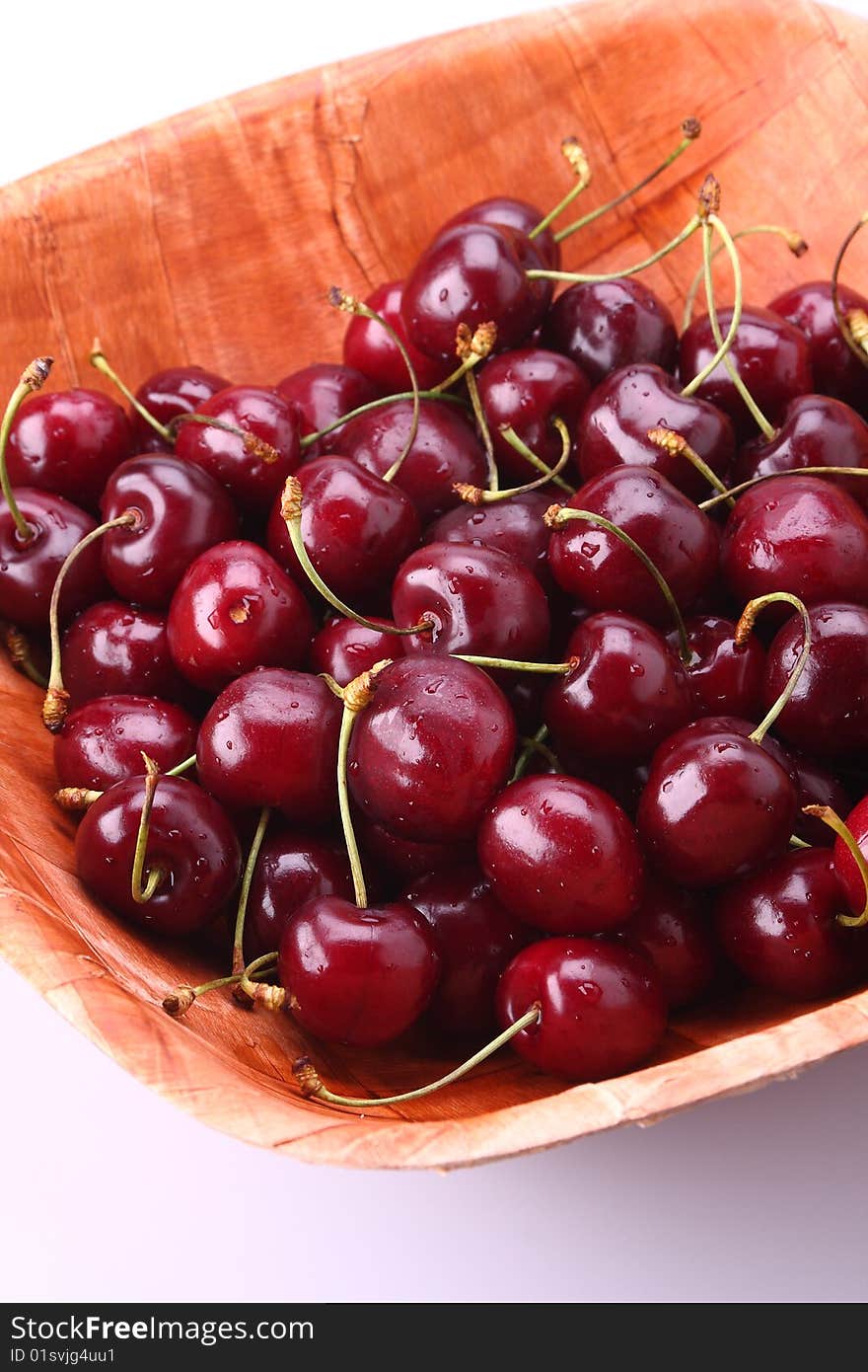 Fresh ripe cherries isolated in bamboo bowl. Fresh ripe cherries isolated in bamboo bowl